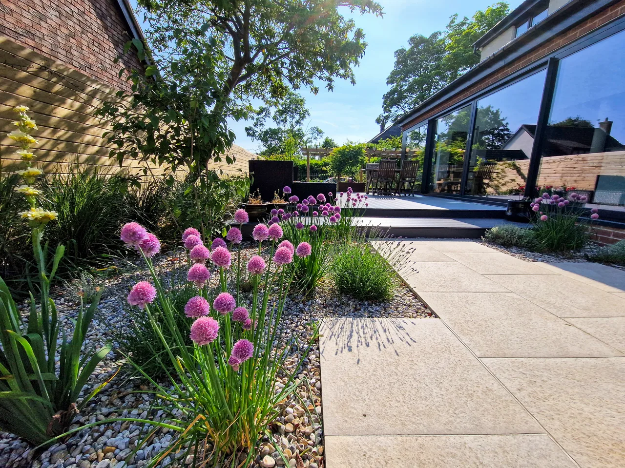 Contemporary garden design - Mediterranean style planting next to a porcelain tile patio in Alwoodley. Yorkshire Gardens, Leeds