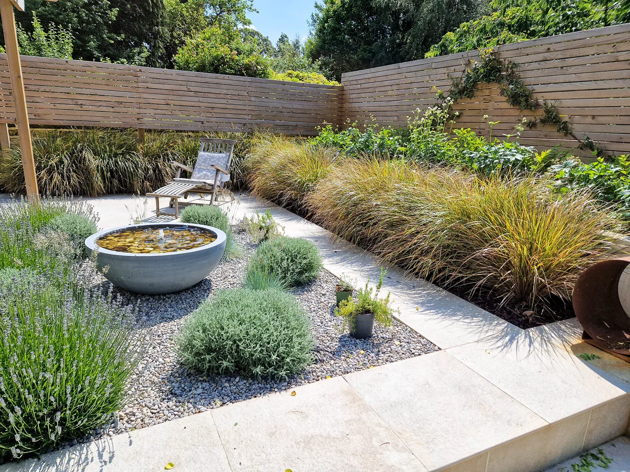 Contemporary garden design - Anemanthele hedge and sparse gravel planting. Yorkshire Gardens, Leeds