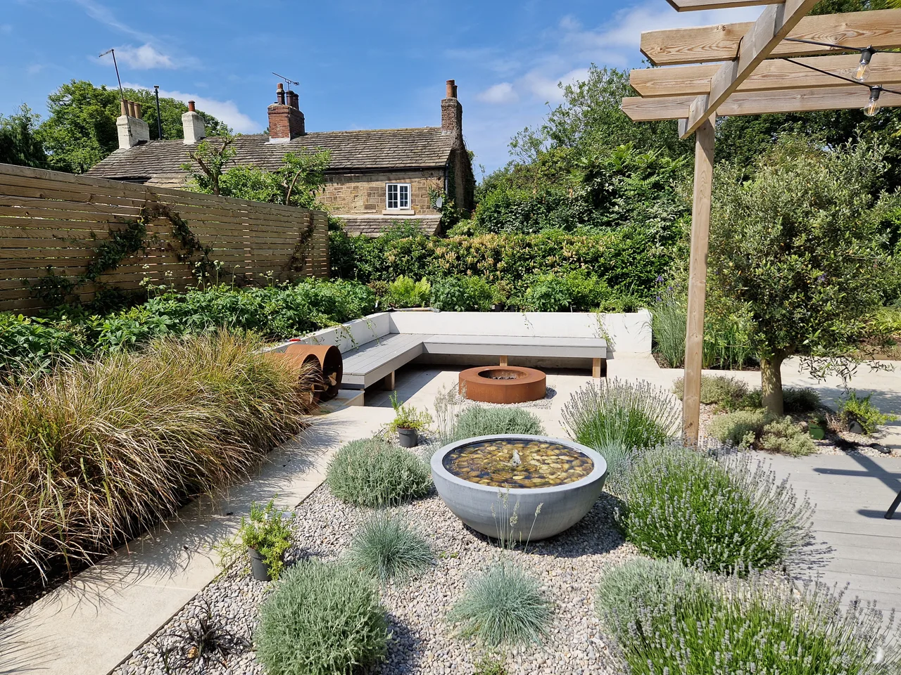 Contemporary garden design - Built-in seating in a sunken patio around a CorTen steel fire pit. Yorkshire Gardens, Leeds